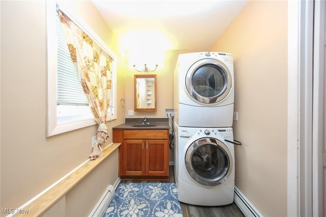 12274 Kile Rd, Chardon, OH 44024 - washroom featuring stacked washer and clothes dryer, cabinet space, a baseboard radiator, and baseboard heating