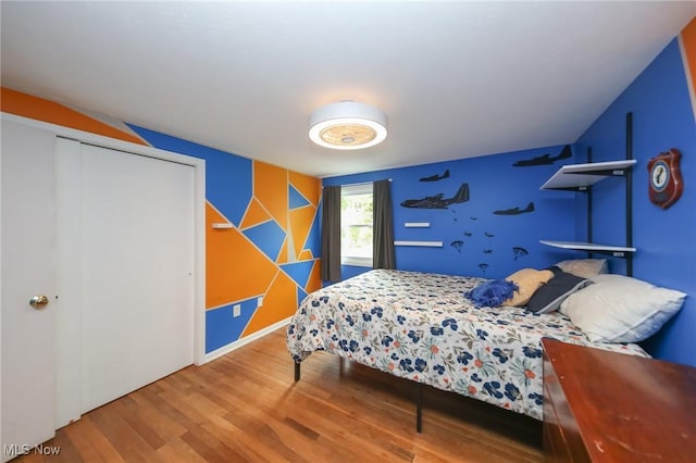 12274 Kile Rd, Chardon, OH 44024 - bedroom with an accent wall, wood finished floors, and a closet