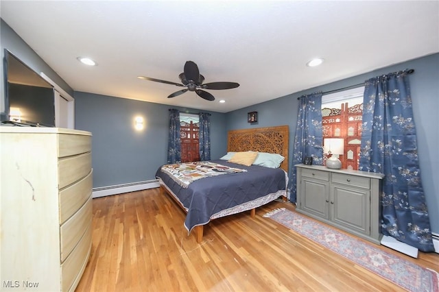 12274 Kile Rd, Chardon, OH 44024 - bedroom with a baseboard heating unit, light wood-style floors, ceiling fan, and recessed lighting