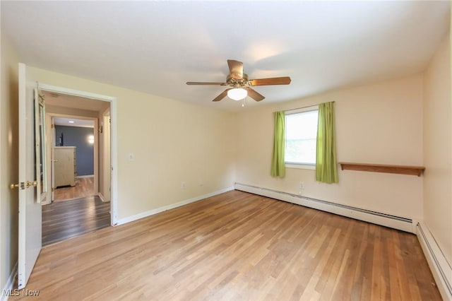 12274 Kile Rd, Chardon, OH 44024 - unfurnished room featuring baseboard heating, a ceiling fan, and light wood-style floors