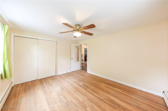 12274 Kile Rd, Chardon, OH 44024 - unfurnished bedroom with baseboard heating, light wood-type flooring, a closet, and a ceiling fan
