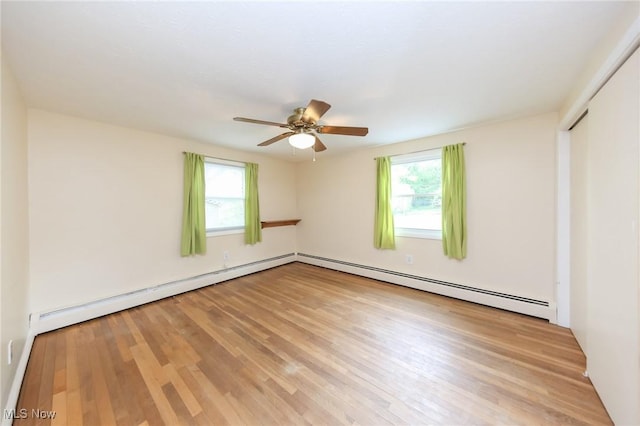 12274 Kile Rd, Chardon, OH 44024 - unfurnished bedroom featuring light wood-style floors, a baseboard heating unit, a closet, and a ceiling fan