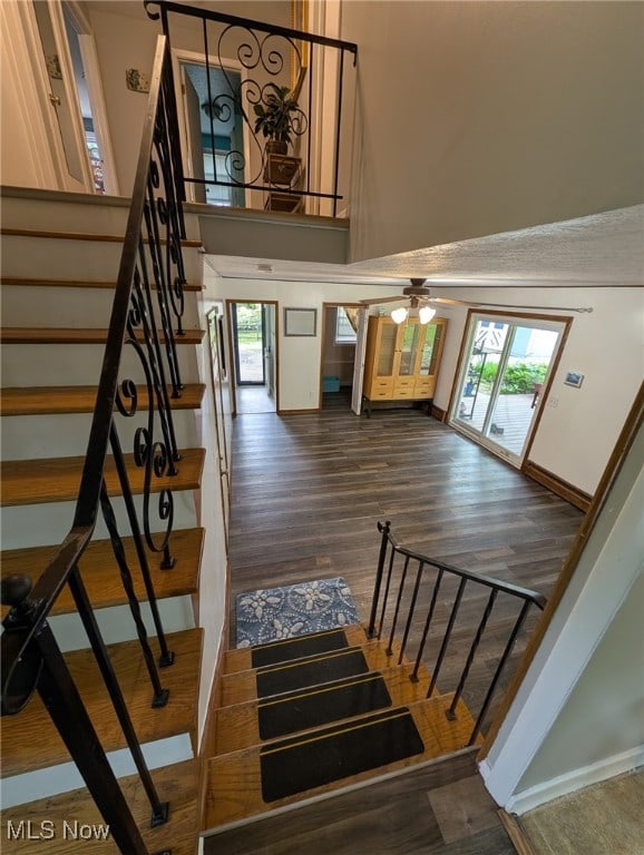 12274 Kile Rd, Chardon, OH 44024 - staircase featuring wood finished floors, a towering ceiling, and a ceiling fan