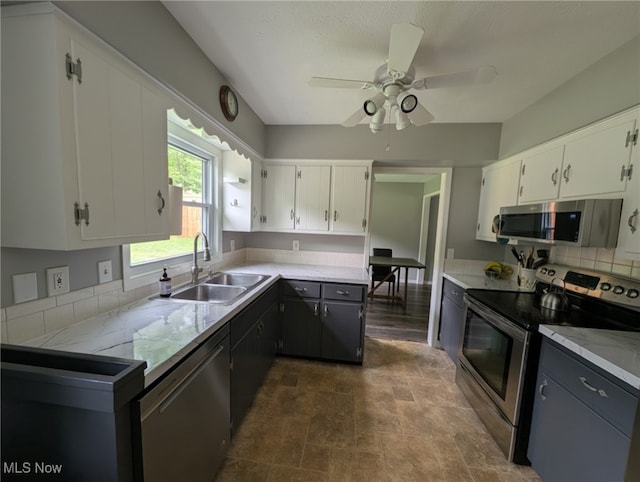 12274 Kile Rd, Chardon, OH 44024 - kitchen featuring appliances with stainless steel finishes, white cabinets, light countertops, and a ceiling fan
