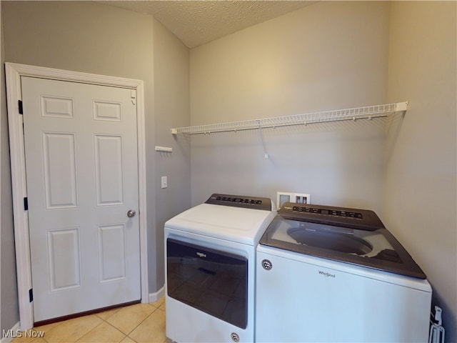4171 Appleridge Ln, Richfield, OH 44286 - laundry area featuring independent washer and dryer, light tile patterned flooring, and baseboards