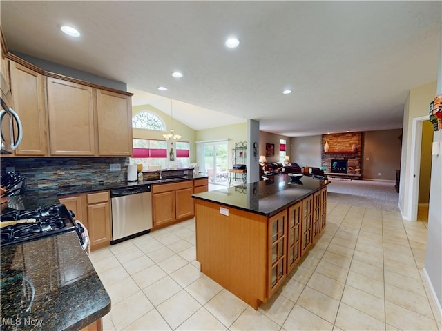 4171 Appleridge Ln, Richfield, OH 44286 - kitchen with stainless steel dishwasher, open floor plan, a large fireplace, vaulted ceiling, and light tile patterned flooring