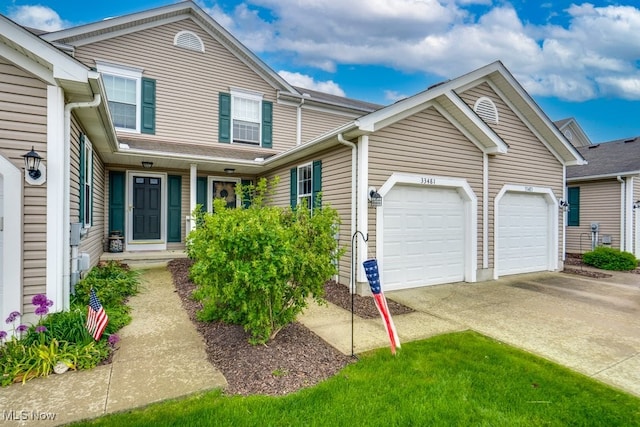 33481 Shelly Ct, Avon Lake, OH 44012 - view of front of home with driveway, a garage, and covered porch