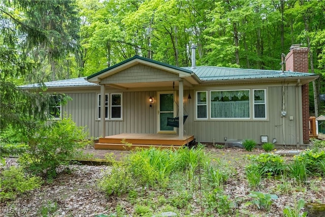 17444 Old State Rd, Middlefield, OH 44062 - view of front of house featuring metal roof, a porch, and board and batten siding