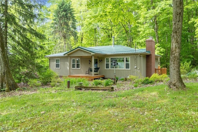 17444 Old State Rd, Middlefield, OH 44062 - ranch-style home featuring a chimney, a porch, metal roof, and board and batten siding