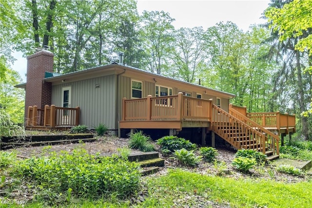 17444 Old State Rd, Middlefield, OH 44062 - back of property featuring a wooden deck, a chimney, and stairs