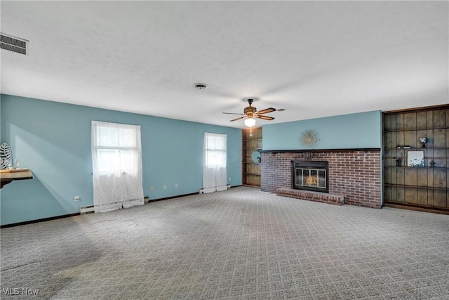 380 Longview Rd, Medina, OH 44256 - unfurnished living room with a ceiling fan, carpet floors, a fireplace, a baseboard radiator, and baseboards