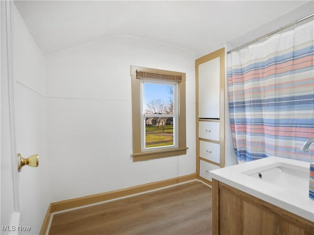 3000 Spitler Rd, Youngstown, OH 44514 - full bath with wood finished floors, vanity, vaulted ceiling, and baseboards