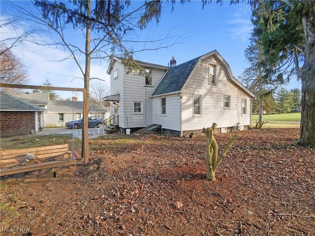 3000 Spitler Rd, Youngstown, OH 44514 - rear view of property featuring a gambrel roof, roof with shingles, and a chimney