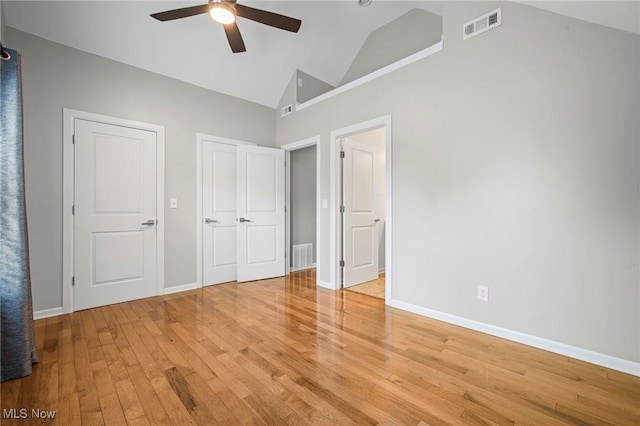 2450 Tremont Ave, Cleveland, OH 44113 - unfurnished bedroom featuring light wood-type flooring, ceiling fan, and high vaulted ceiling