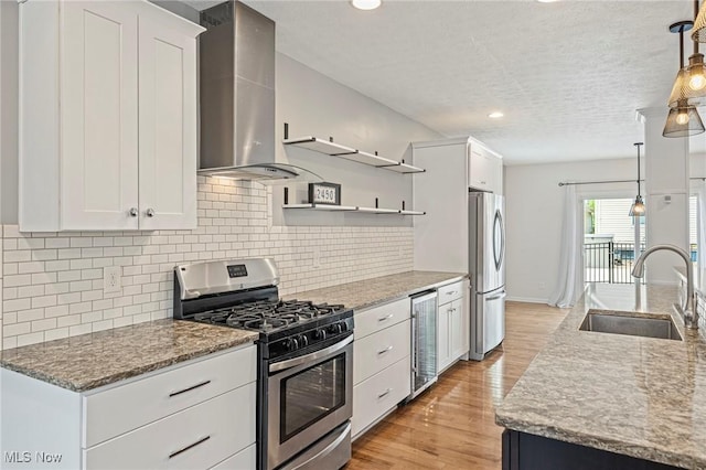 2450 Tremont Ave, Cleveland, OH 44113 - kitchen with stainless steel appliances, wine cooler, wall chimney range hood, open shelves, and light wood-type flooring