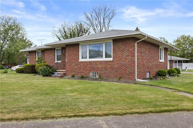 4002 Canterbury Ct, Lorain, OH 44053 - view of property exterior with brick siding and a yard
