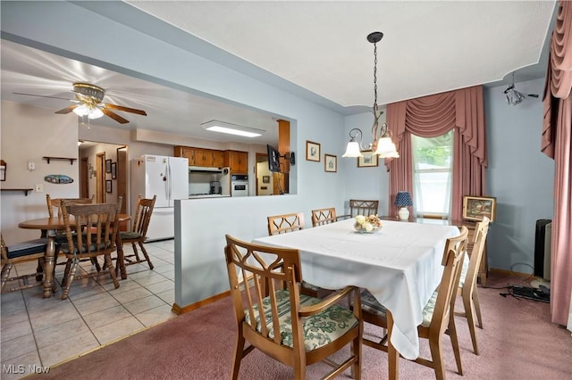 4002 Canterbury Ct, Lorain, OH 44053 - dining area featuring a ceiling fan, light carpet, baseboards, and light tile patterned floors
