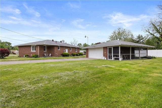 4002 Canterbury Ct, Lorain, OH 44053 - rear view of property featuring concrete driveway, brick siding, and an attached garage