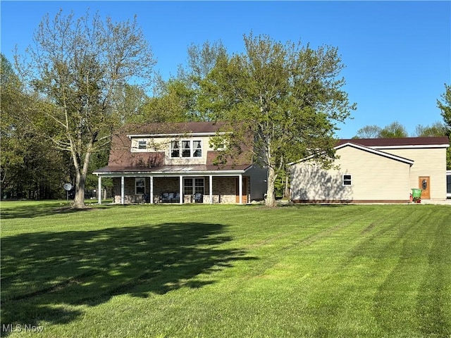 6516 Fee Rd, Rome, OH 44085 - back of house featuring covered porch and a yard