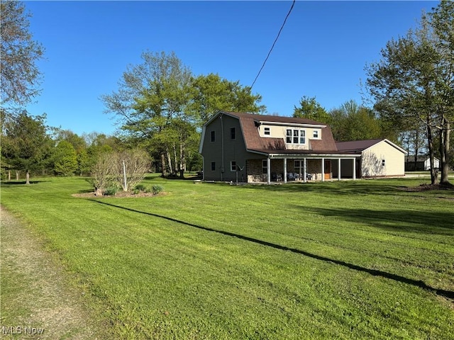 6516 Fee Rd, Rome, OH 44085 - rear view of house featuring a gambrel roof, covered porch, and a yard