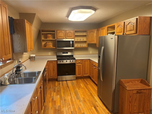 6516 Fee Rd, Rome, OH 44085 - kitchen with open shelves, appliances with stainless steel finishes, a sink, light wood finished floors, and light countertops
