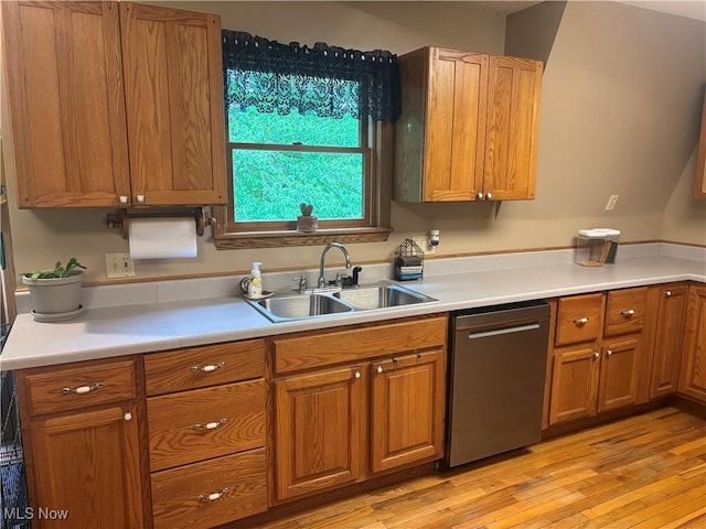 6516 Fee Rd, Rome, OH 44085 - kitchen with stainless steel dishwasher, a sink, brown cabinets, and light wood-type flooring