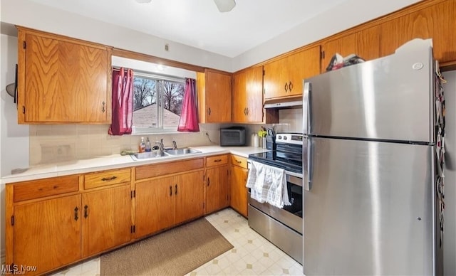 432-434 N Main St, Munroe Falls, OH 44262 - kitchen featuring appliances with stainless steel finishes, a sink, light flooring, under cabinet range hood, and brown cabinetry