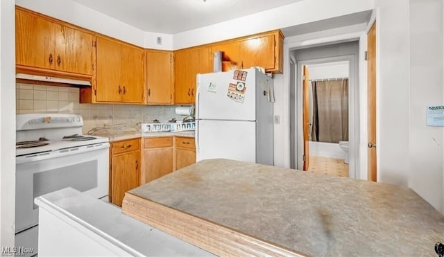 432-434 N Main St, Munroe Falls, OH 44262 - kitchen featuring white appliances, under cabinet range hood, backsplash, light countertops, and brown cabinetry