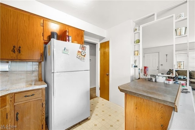 432-434 N Main St, Munroe Falls, OH 44262 - kitchen with freestanding refrigerator, brown cabinetry, tasteful backsplash, and light flooring