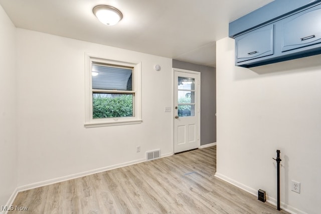 2318 3rd St SE, Canton, OH 44707 - empty room featuring light wood-type flooring, healthy amount of natural light, and baseboards