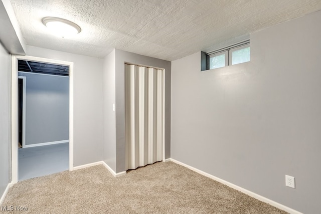 2318 3rd St SE, Canton, OH 44707 - basement with carpet flooring, a textured ceiling, and baseboards