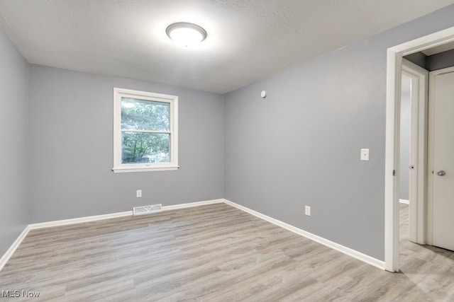 2318 3rd St SE, Canton, OH 44707 - unfurnished room featuring light wood finished floors and baseboards