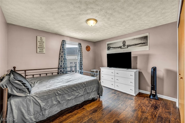 2300 Canterbury Cir, Akron, OH 44319 - bedroom featuring wood finished floors, baseboards, and a textured ceiling