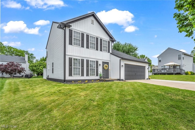 2300 Canterbury Cir, Akron, OH 44319 - view of front of property with concrete driveway, an attached garage, a front lawn, and board and batten siding