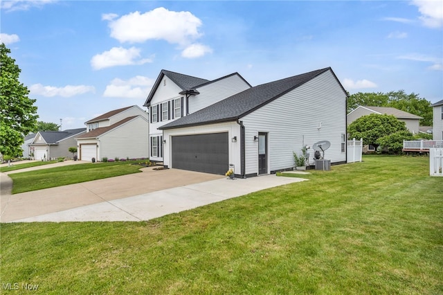 2300 Canterbury Cir, Akron, OH 44319 - view of side of property featuring driveway, a lawn, a shingled roof, and an attached garage