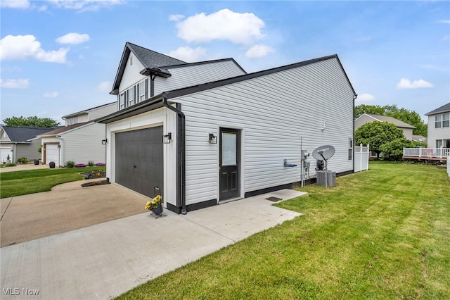 2300 Canterbury Cir, Akron, OH 44319 - view of home's exterior with concrete driveway, a lawn, and an attached garage
