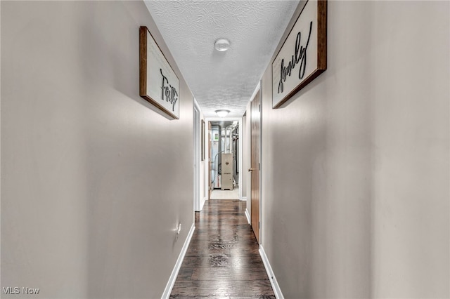 2300 Canterbury Cir, Akron, OH 44319 - hallway with a textured ceiling, dark wood-style flooring, and baseboards