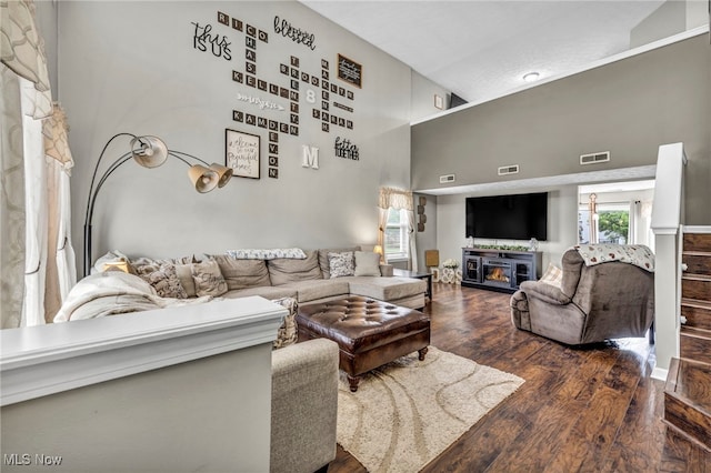 2300 Canterbury Cir, Akron, OH 44319 - living area with wood finished floors, a glass covered fireplace, and a high ceiling