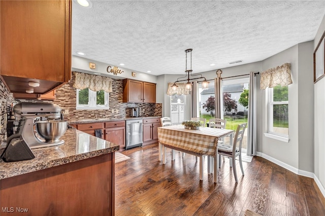 2300 Canterbury Cir, Akron, OH 44319 - kitchen featuring stainless steel dishwasher, brown cabinets, decorative backsplash, dark wood-type flooring, and baseboards