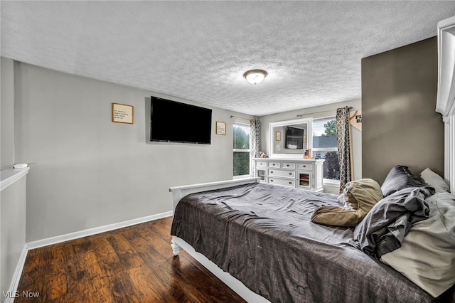 2300 Canterbury Cir, Akron, OH 44319 - bedroom with baseboards, dark wood-style flooring, and a textured ceiling