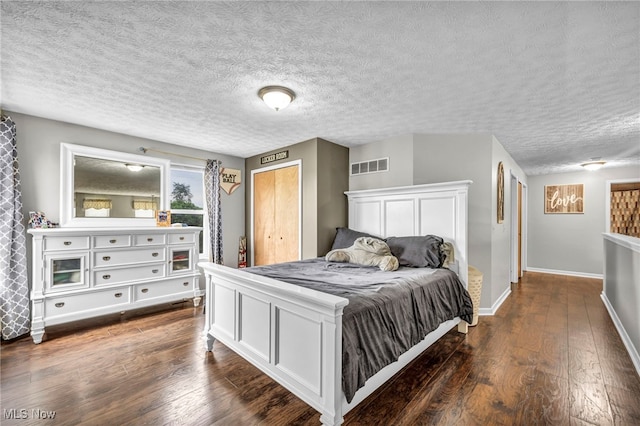 2300 Canterbury Cir, Akron, OH 44319 - bedroom featuring dark wood finished floors, baseboards, and a textured ceiling
