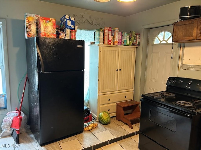 1103 Sharon Ave, Zanesville, OH 43701 - kitchen featuring black appliances, light tile patterned flooring, and light countertops