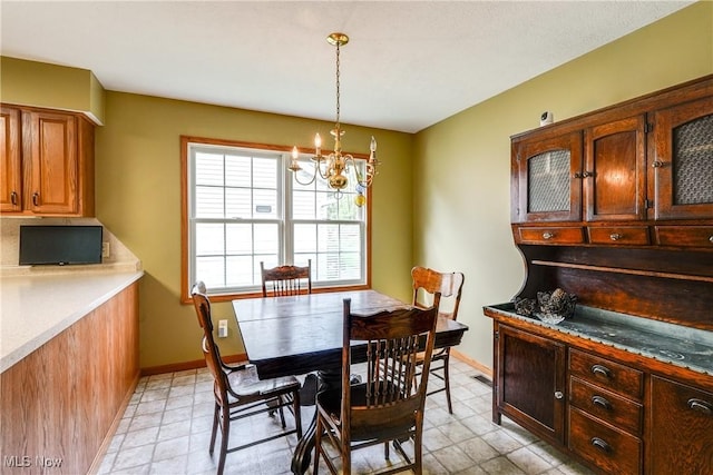 3690 Dornoch Dr, Wooster, OH 44691 - dining area with a chandelier and baseboards