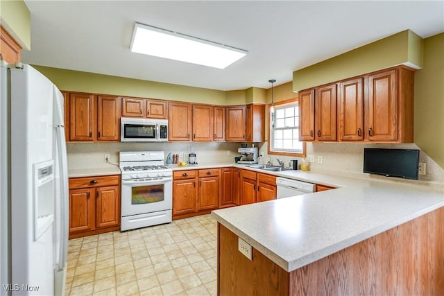 3690 Dornoch Dr, Wooster, OH 44691 - kitchen featuring white appliances, a peninsula, brown cabinetry, and light countertops