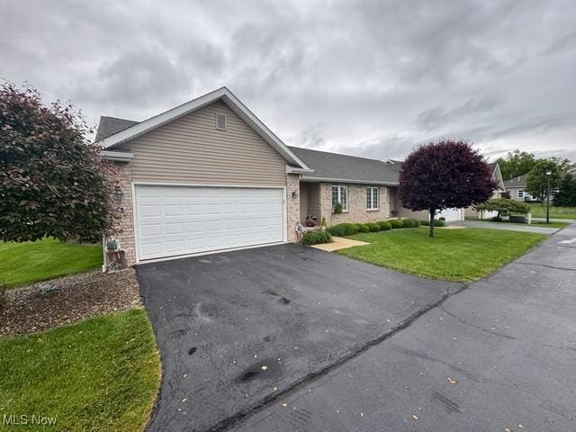 6 Danbury Ct, Warren, OH 44483 - single story home with asphalt driveway, an attached garage, brick siding, and a front yard