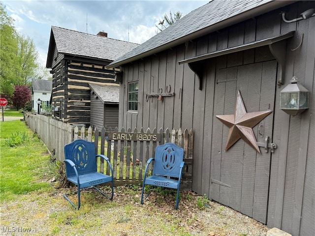 199 E 3rd St, Zoar, OH 44697 - view of home's exterior featuring a chimney, board and batten siding, and roof with shingles