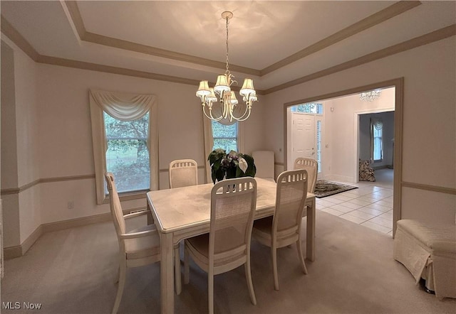 592 Charles Pl, Highland Heights, OH 44143 - dining area with a chandelier, a tray ceiling, light colored carpet, ornamental molding, and baseboards