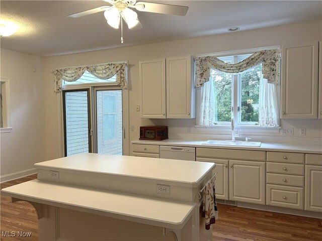 592 Charles Pl, Highland Heights, OH 44143 - kitchen featuring a sink, wood finished floors, white cabinets, light countertops, and a center island