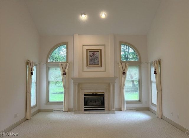 592 Charles Pl, Highland Heights, OH 44143 - unfurnished living room with carpet flooring, healthy amount of natural light, baseboards, a glass covered fireplace, and vaulted ceiling