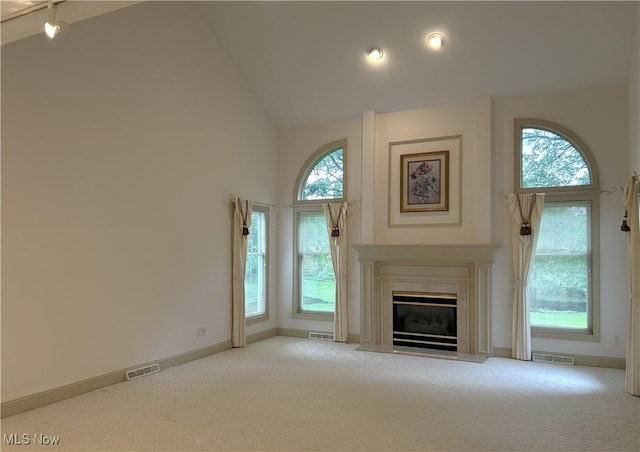 592 Charles Pl, Highland Heights, OH 44143 - unfurnished living room featuring carpet, baseboards, a glass covered fireplace, and high vaulted ceiling